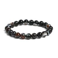 A bottle of pure Black Agate from Seamoss Africa, used for grounding energy stabilization and root chakra balancing.